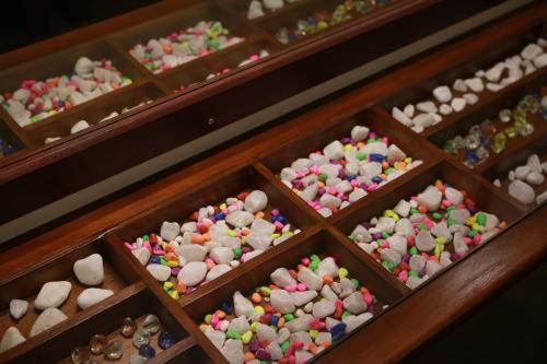 a bunch of wooden boxes filled with different colored buttons at Cozy Sea view Inn in Hikkaduwa