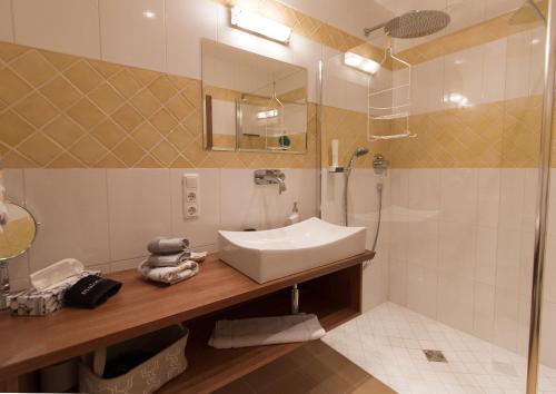 a bathroom with a sink and a shower at Hotel Alpenblick in Riedering