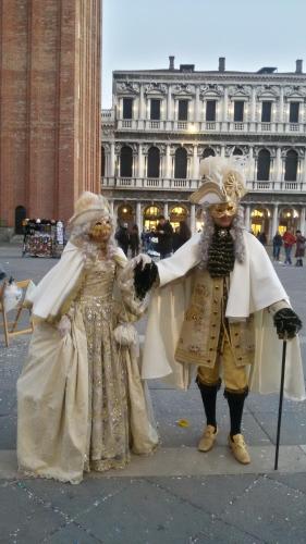 two people dressed in costumes standing on a city street at B&B Terre Di Bea in Pederobba