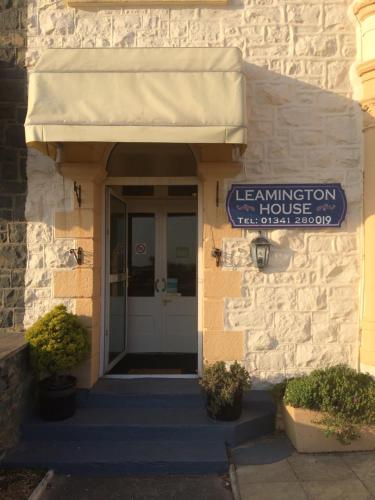 a entrance to a building with a sign on it at Leamington House in Barmouth