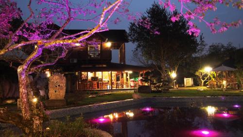 a resort with a pond in front of a building at Moon River Villa in Puli