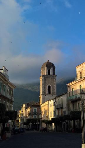 a building with a clock tower in a city at Antichi Feudi Dimora D'Epoca in Teggiano