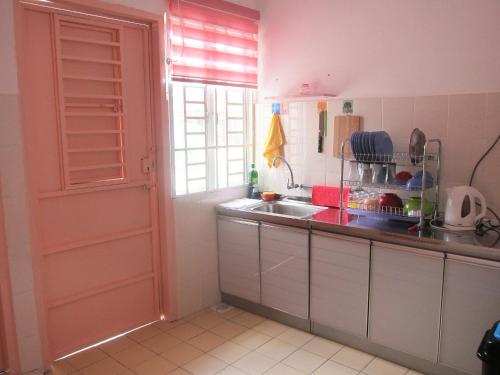 a kitchen with a sink and a counter top at MILU Homestay - Kuala Selangor in Kuala Selangor