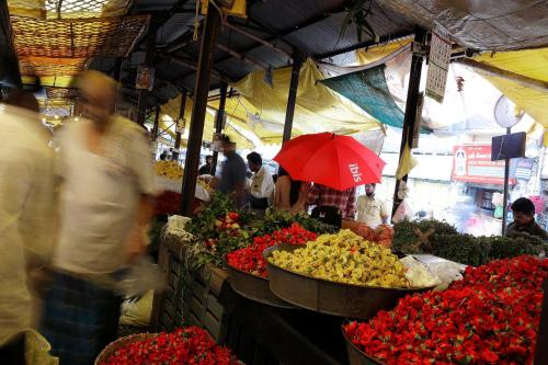 a group of people walking around a market with flowers at ibis Coimbatore City Centre - An Accor Brand in Coimbatore