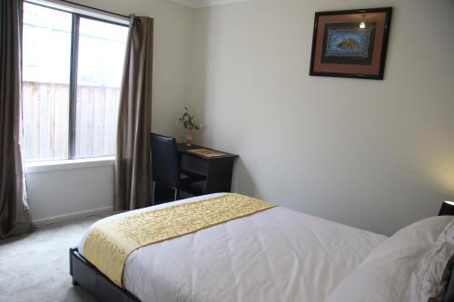a bedroom with a bed and a window at Apple House in Tarneit
