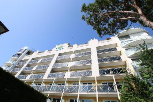 a white building with a lot of windows at Eraclea Palace Hotel 4 stelle S in Eraclea Mare