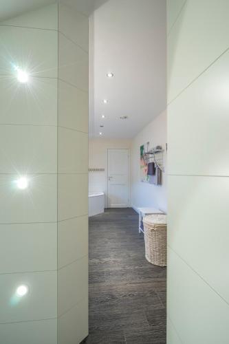 a room with white walls and a hallway with a table at Villa Scandic Apartments in Rust
