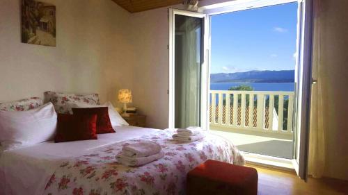 a bedroom with a bed and a large window with a view at Apartments Kristian in Bol