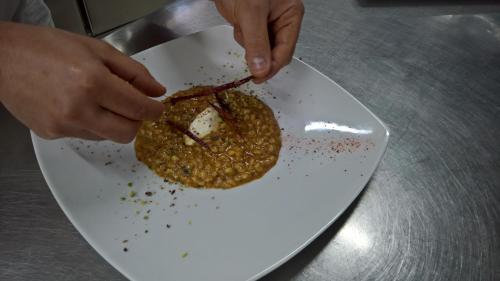 a person eating a piece of food on a plate at Antichi Feudi Dimora D'Epoca in Teggiano