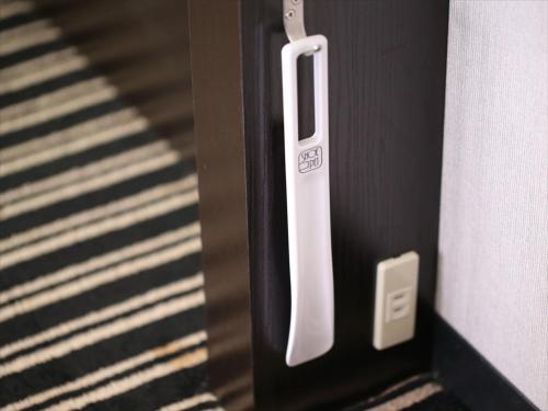 a close up of a door with a white handle at APA Hotel Yamagata Tsuruoka Ekimae in Tsuruoka