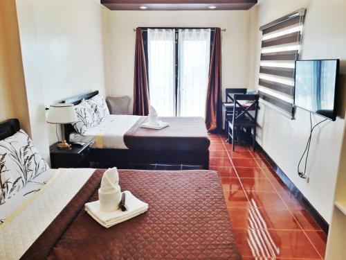 a hotel room with two beds and a window at Bayview Country Inn El Nido in El Nido
