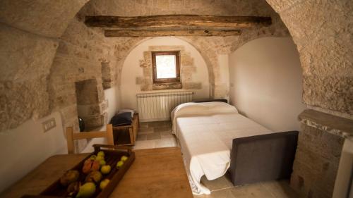 a bedroom with a bed and a tray of fruit in a room at B&B Trulli Mansio in Alberobello