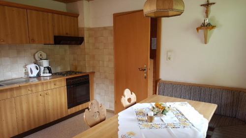 a kitchen with a wooden table with a white table cloth at Gasperlerhof in Neustift im Stubaital