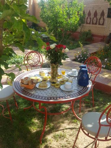 a table with a plate of food on it at Riad Villa Midelt in Midelt