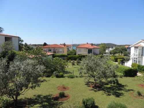 a view of a garden with trees and houses at Kosovic Family House in Medulin