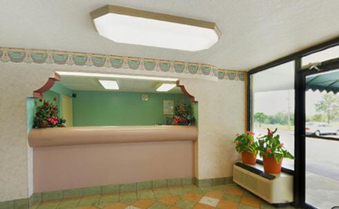 a room with a mirror and some plants in it at Super Inn in Tillmans Corner