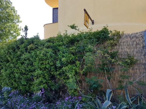 a fence with a sign on the side of a building at Il Silos in Maccarese