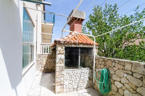 a building with a brick chimney on top of a wall at Cina Apartments in Cavtat