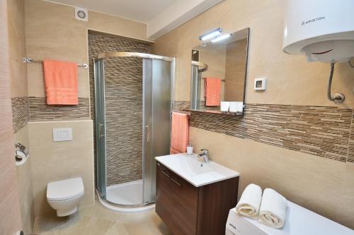 a bathroom with a shower toilet and a sink at Studio Apartment Colors of Dubrovnik in Dubrovnik
