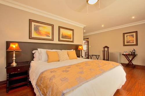 a bedroom with a large bed in a room at Leopardsong Manor in Centurion
