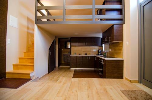 a kitchen with wooden floors and a staircase in a house at Gonis Suites in Palaiochora