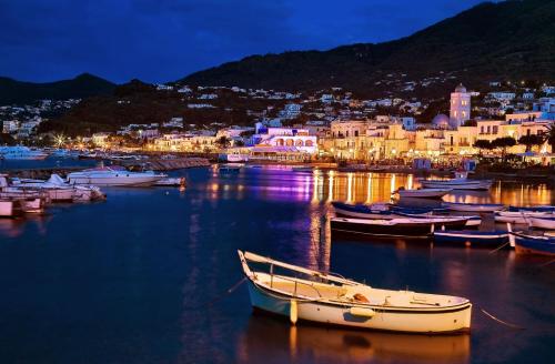 a group of boats docked in a harbor at night at Hotel La Sirenella in Ischia
