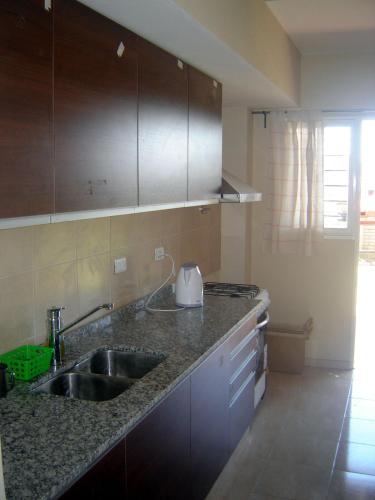 a kitchen with a sink and a counter top at Duplex Kirara in Santa Lucía