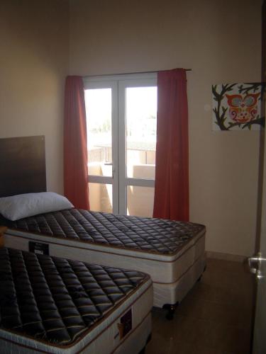 a bedroom with two beds and a window at Duplex Kirara in Santa Lucía