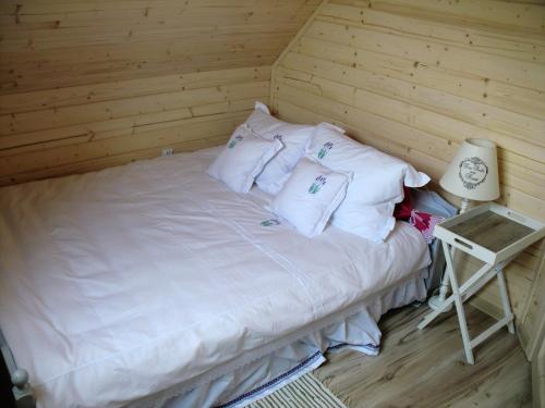 a bed with white sheets and pillows in a room at Lawendowa Dolina in Ustroń