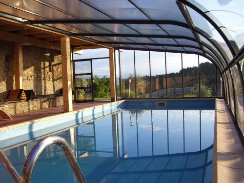 a swimming pool with a view of the mountains at Il Sartù in Dogliani