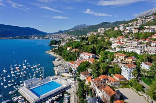 an aerial view of a city and a harbor with boats at Guest House Bajceta in Herceg-Novi