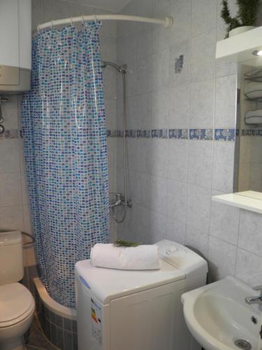 uma casa de banho com um chuveiro, um WC e um lavatório. em Apartment Adria em Trogir