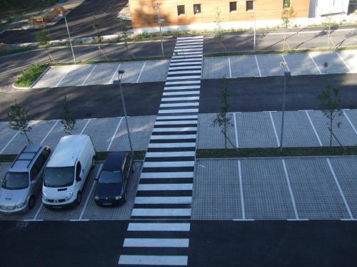 an aerial view of a parking lot with trucks and cars at Ekho Hotel Grenoble Nord Saint Egrève in Saint-Égrève