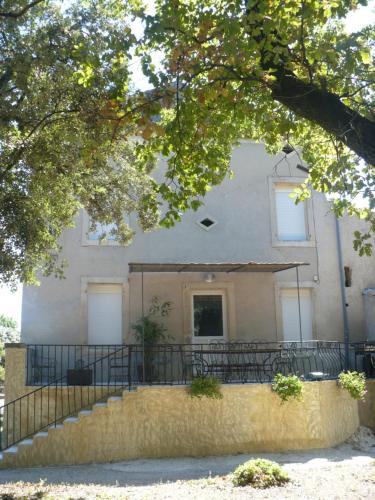 a building with a staircase in front of it at GITE DE LA GARÈNE in Grillon