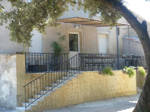a staircase leading to a house with a balcony at GITE DE LA GARÈNE in Grillon