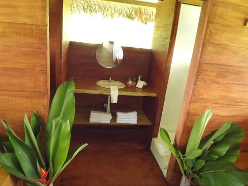 a bathroom with a sink and a mirror at Ecolucerna Lodge Tambopata in Puerto Maldonado