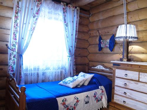 a bedroom with a bed in a log cabin at Hotel Arkhangelskaya Dacha in Zvenigorod