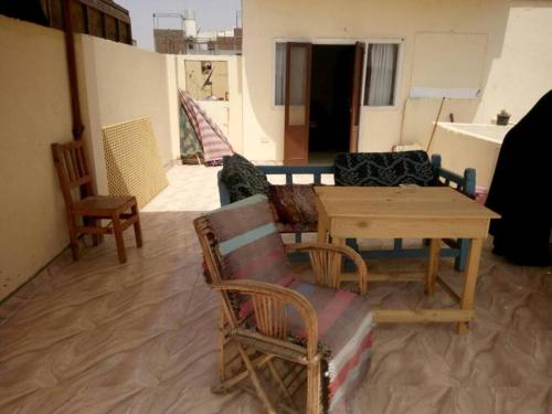 a living room with a table and chairs at Blue Sky Apartments in Luxor