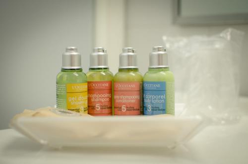 a group of four sauce bottles sitting on a shelf at Hotel Ovidius in Sulmona
