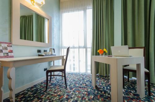 a hotel room with a desk and a laptop on it at Hotel Ovidius in Sulmona