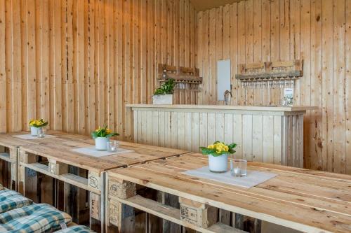 a room with a wooden table with flowers on it at Landhotel Bartmann in Sendenhorst