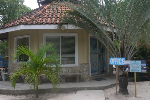 a small house with a sign in front of it at Fosters West Bay Resort in West Bay