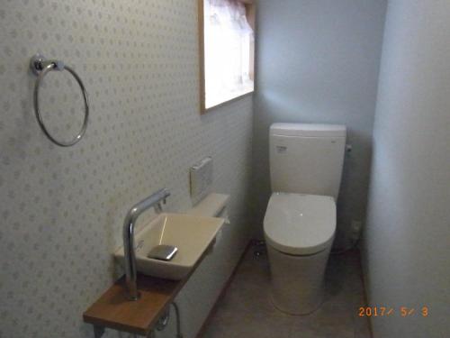 a bathroom with a toilet and a sink at Oyajino Umi in Naoshima