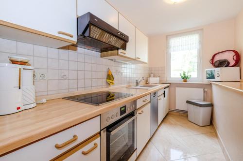 a kitchen with a sink and a stove at Ferienhaus Harzidyll in Schierke