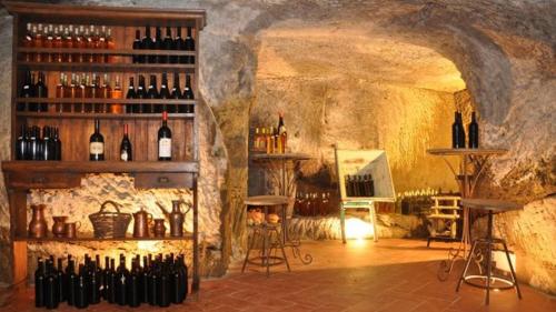 a room with a bunch of bottles of wine at L'orto di Hans in Soriano nel Cimino