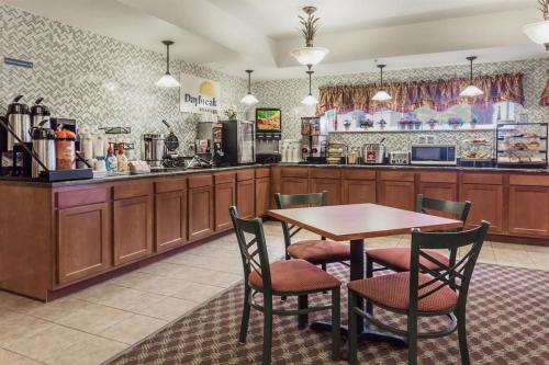 a restaurant with a table and chairs and a kitchen at Days Inn by Wyndham Manitou Springs in Manitou Springs