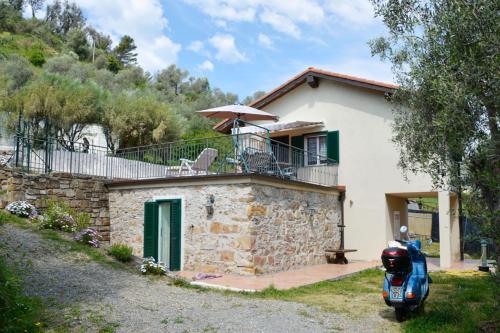 a house with a scooter parked in front of it at Casa Delle Olive in Dolceacqua