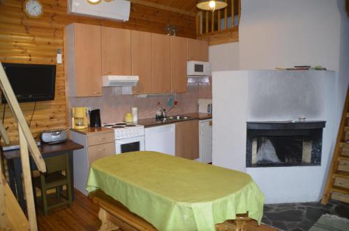 a small kitchen with a stove and a fireplace at Maatilamatkailu Heikin Tupa in Ylipää
