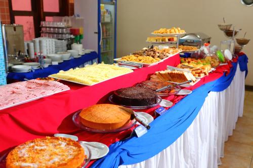 a long table filled with different types of food at Boulevard da Praia Apart Hotel in Porto Seguro