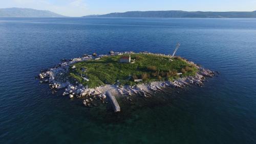 an island in the middle of a body of water at Pansion Ruža in Novi Vinodolski